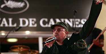 Bono performing live in front of the Festival Palais at Cannes, 20 May