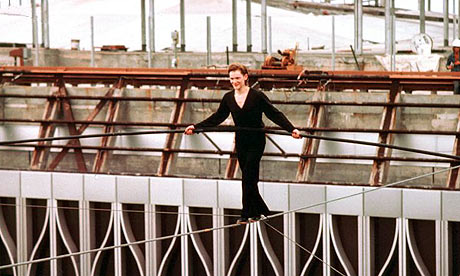 Philippe Petit walks on a cable suspended between the notyetcompleted twin