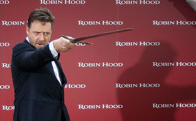 Russell Crowe poses with a sword at a Robin Hood photocall in Madrid