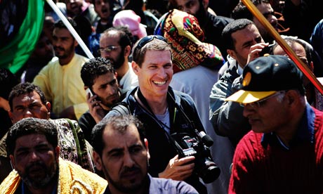 Tim Hetherington with his camera at a rebel rally in Benghazi last month.