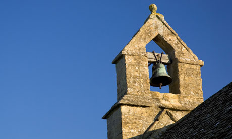 Bell tower of St Oswald's church in Widford Cotswolds Oxfordshire UK