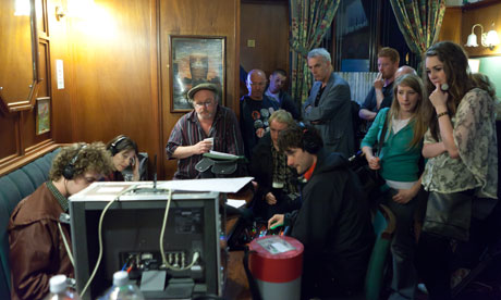 Niall Griffiths and the Kelly+Victor cast in a pub room with film equipment