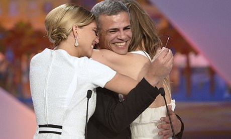 Lea Seydoux (left) and Adele Exarchopoulos embrace director Abdellatif Kechiche