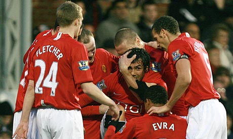 Tevez is congratulated by his team mates