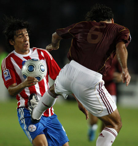 World Cup qualifiers: Paraguay's Edgar Benitez gets a kick from Venezuela's Oswaldo Vizcarrondo