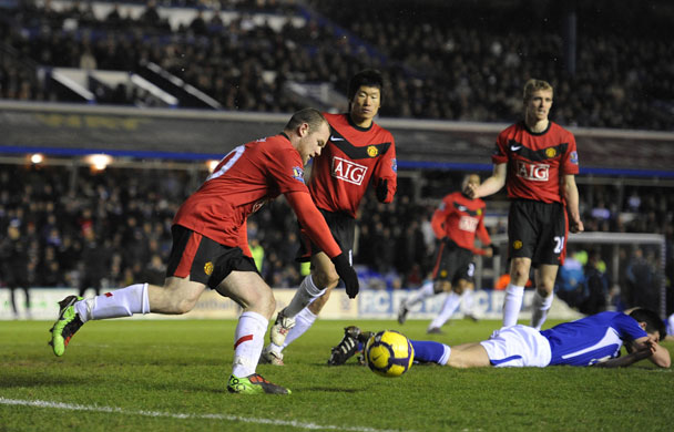 Birmingham: Wayne Rooney collects the ball after the own goal by Scott Dann