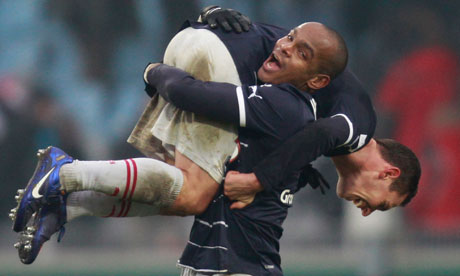 Bordeaux's Ludovic Obraniak is lifted up by Henrique Dit after securing the victory over Lille