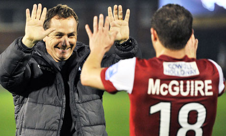 Fleetwood Town manager Micky Mellon celebrates with Jamie McGuire