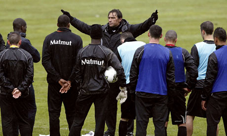 Quevilly's head coach, Regis Brouard, instructs his players during training