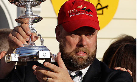'll Have Another's trainer, Doug O'Neill, holds the Preakness trophy after I'll Have Another won