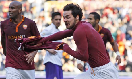Roma's Mattia Destro removes his shirt as he celebrates scoring the winner against Fiorentina