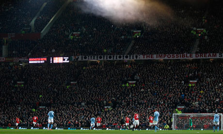 Fans watch Manchester United at Old Trafford