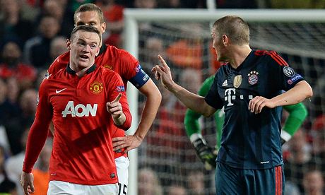 Bayern's Bastian Schweinsteiger fumes at Manchester United's Wayne Rooney after being sent off