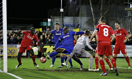 Steven Gerrard can only watch as AFC Wimbledon's Adebayo Akinfenwa scores against Liverpool