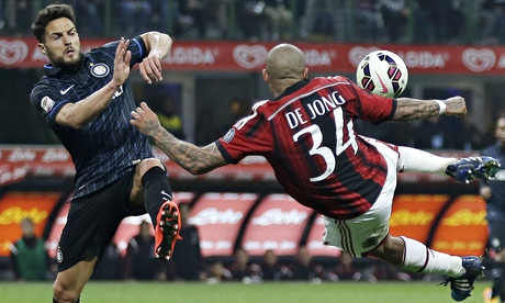 Milan's Nigel de Jong gets to the ball ahead of Internazionale's Danilo D'Ambrosio at San Siro