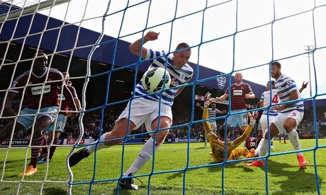 QPR's Richard Dunne raises an arm in celebration but his goal against West Ham United was disallowed