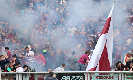 Smoke envelopes the Torino supporters after a paper bomb exploded during the Serie A match against Juventus