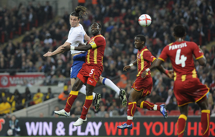 England v Ghana: Andy Carroll wins a header against Mensah