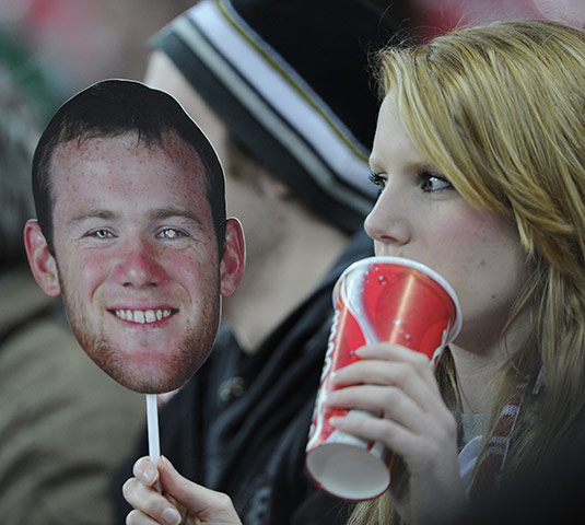 England v Ghana: Wayne Rooney fan holds a mask of her hero