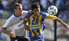Boca Juniors' Martin Palermo (L) vies for the ball with Rosario Central's Damian Ledesma