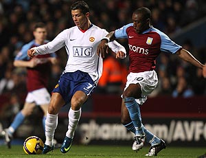 Nigel Reo-Coker and Cristiano Ronaldo battle for the ball
