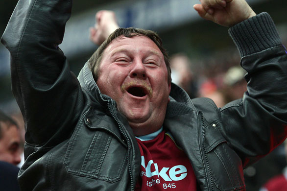 Premier League round-up: A Burnley fan celebrates after his team take an early lead at Blackburn