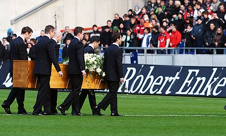 Hannover 96 players carry out the coffin of Robert Enke during the memorial service at AWD Arena