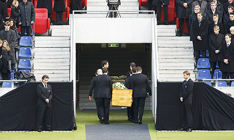 Pall bearers carry the coffin holding body of Robert Enke at the end of the memorial service