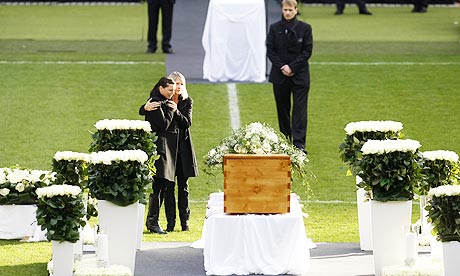 Teresa Enke with her late husband Robert's coffin at the memorial service