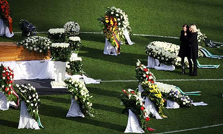 Teresa Enke with her late husband Robert's coffin at the memorial service for the goalkeeper.