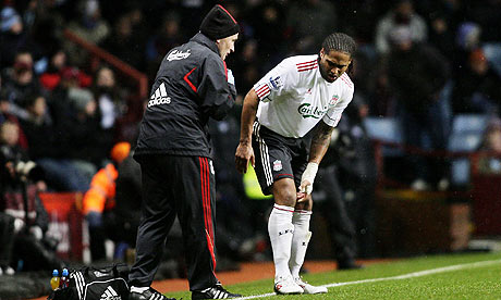 Glen Johnson holds his injured knee