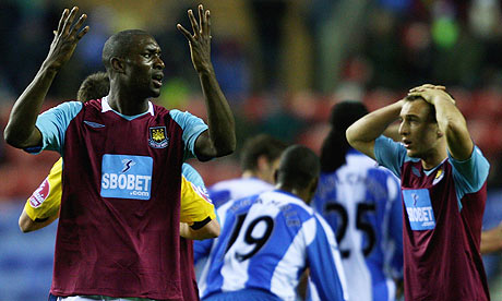 Carlton Cole reacts after his red card