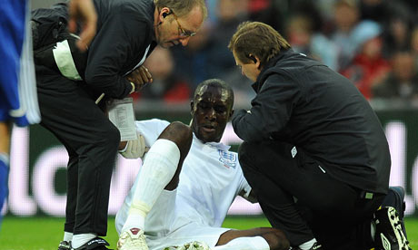 England's Carlton Cole receives treatment for his injury at Wembley