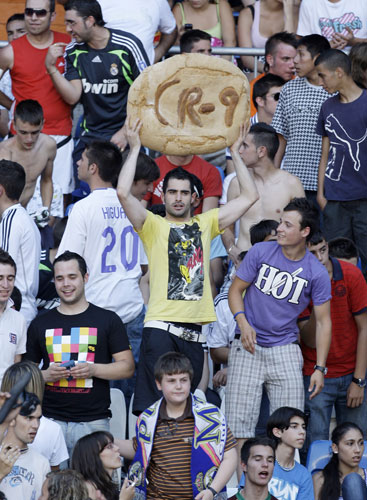 Cristiano Ronaldo: A Real Madrid fan holds up a loaf of bread in tribute to Cristiano Ronaldo