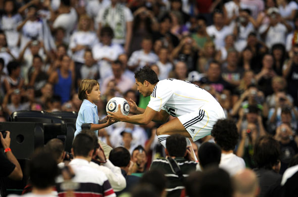 Cristiano Ronaldo: Cristiano Ronaldo gives a ball to a child during his Real Madrid unveiling