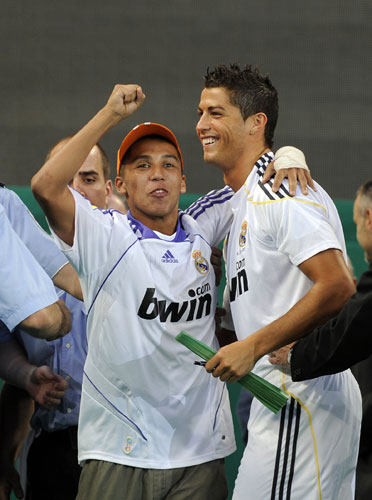 Cristiano Ronaldo: A fan hugs Cristiano Ronaldo after invading the pitch during his unveiling