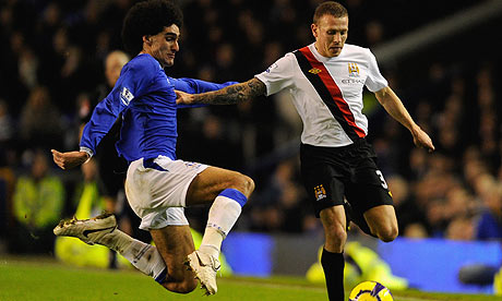 Marouane Fellaini tackles Craig Bellamy during Everton's win over Manchester City