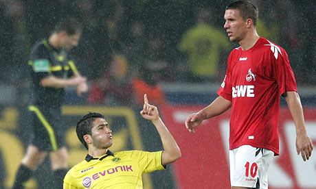 Dortmund's Nuri Sahin celebrates scoring in front of Lukas Podolski