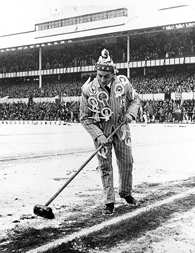 Football white-outs: A Spurs fan sweeps the snow from the lines