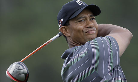 Tiger Woods watches his tee shot on the first hole during the  first round of the Masters