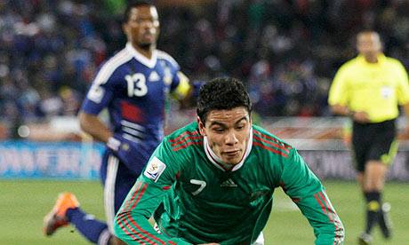 Mexico's Pablo Barrera goes flying as France's Patrice Evra looks on