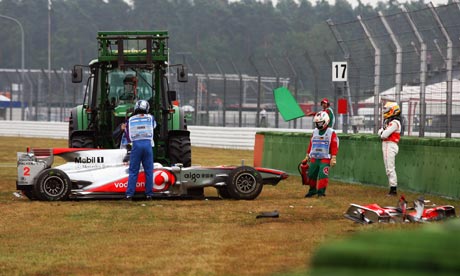 Lewis Hamilton right surveys the scene of his crash during practice at 