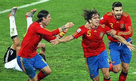 Carles Puyol celebrates with teammates Sergio Ramos left and Gerard Pique