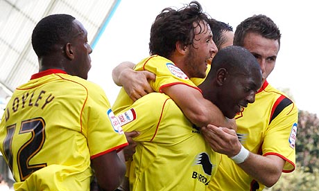 Marvin Sordell celebrates with his team-mates after scoring the third goal for Watford