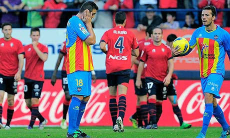 Levante's Sergio Ballesteros, left, reacts after Osasuna scored during their victory