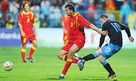 England's Wayne Rooney kicks Miodrag Dzudovic of Montenegro before being sent off in Podgorica