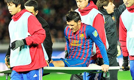 Barcelona's David Villa is carried off after breaking his left leg against