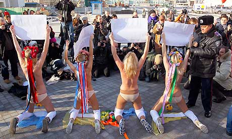 Activists of the Ukrainian feminist group Femen stage a protest near the Olympiyskiy stadium in Kyiv