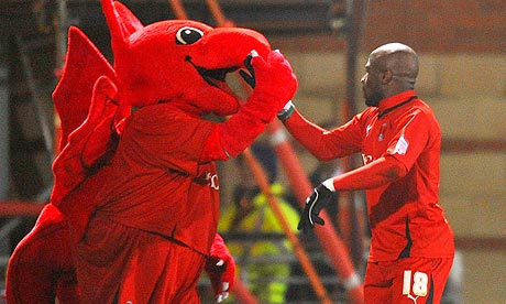 Jonathan Téhoué celebrates with the Leyton Orient mascot