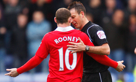 Wayne Rooney pleads his innocence to the referee Mark Clattenburg during 